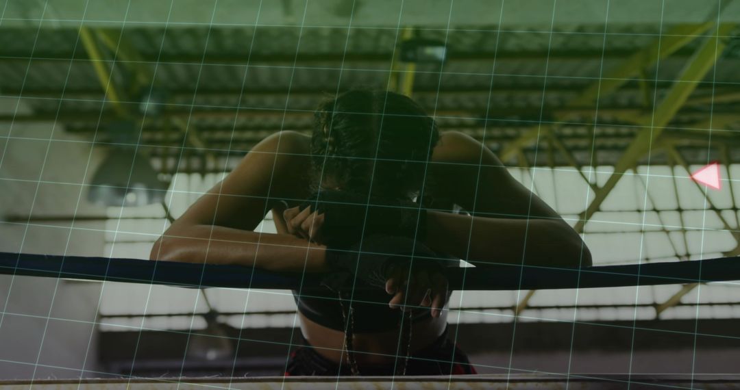 Female Boxer Resting on Ring Ropes in Gym with Determination