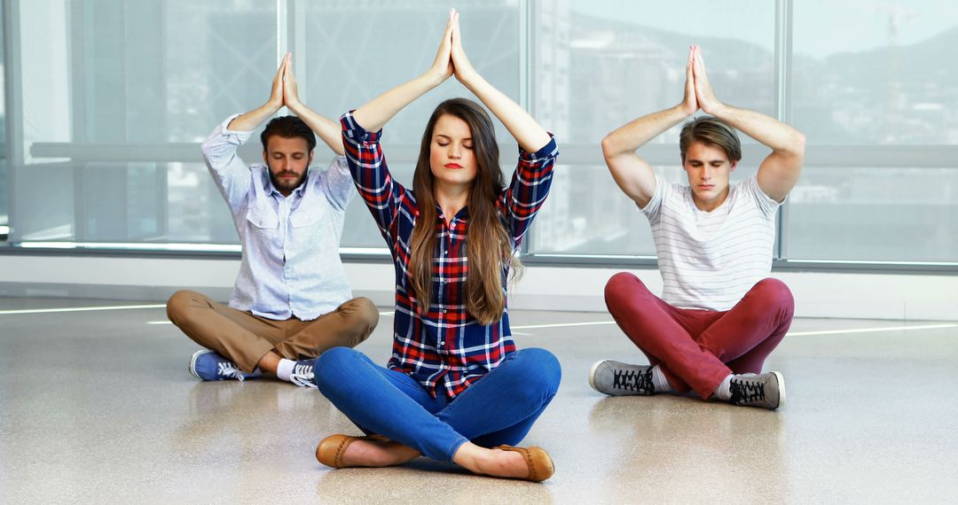 Young Adults Meditating in Office Space with Calm Atmosphere - Free Images, Stock Photos and Pictures on Pikwizard.com