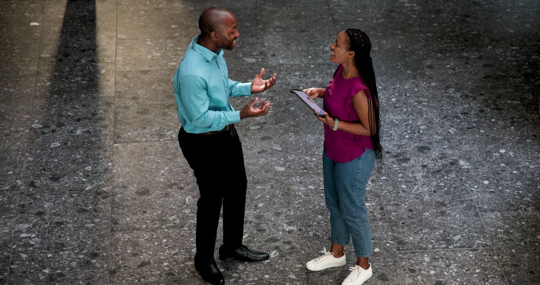 Business Colleagues Engaging in Lively Discussion with Tablet
