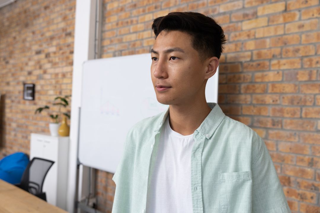 Young Professional in Modern Office Contemplating New Ideas