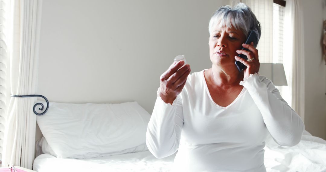 Senior Woman Consulting on Phone About Medication at Home - Free Images, Stock Photos and Pictures on Pikwizard.com