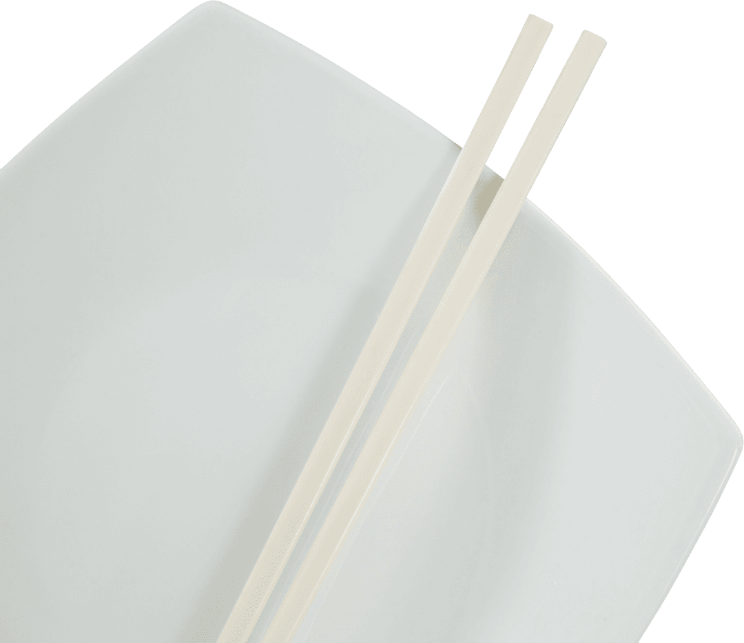 Transparent Chopsticks Resting on Square White Plate