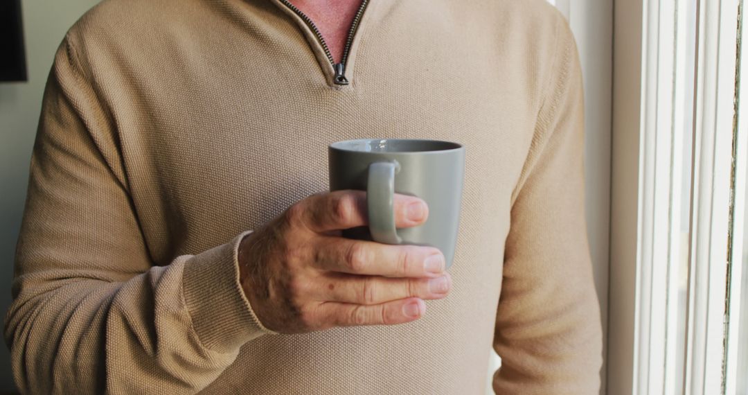 Man Relaxing with Coffee Mug Near Window, Casual Morning - Free Images, Stock Photos and Pictures on Pikwizard.com