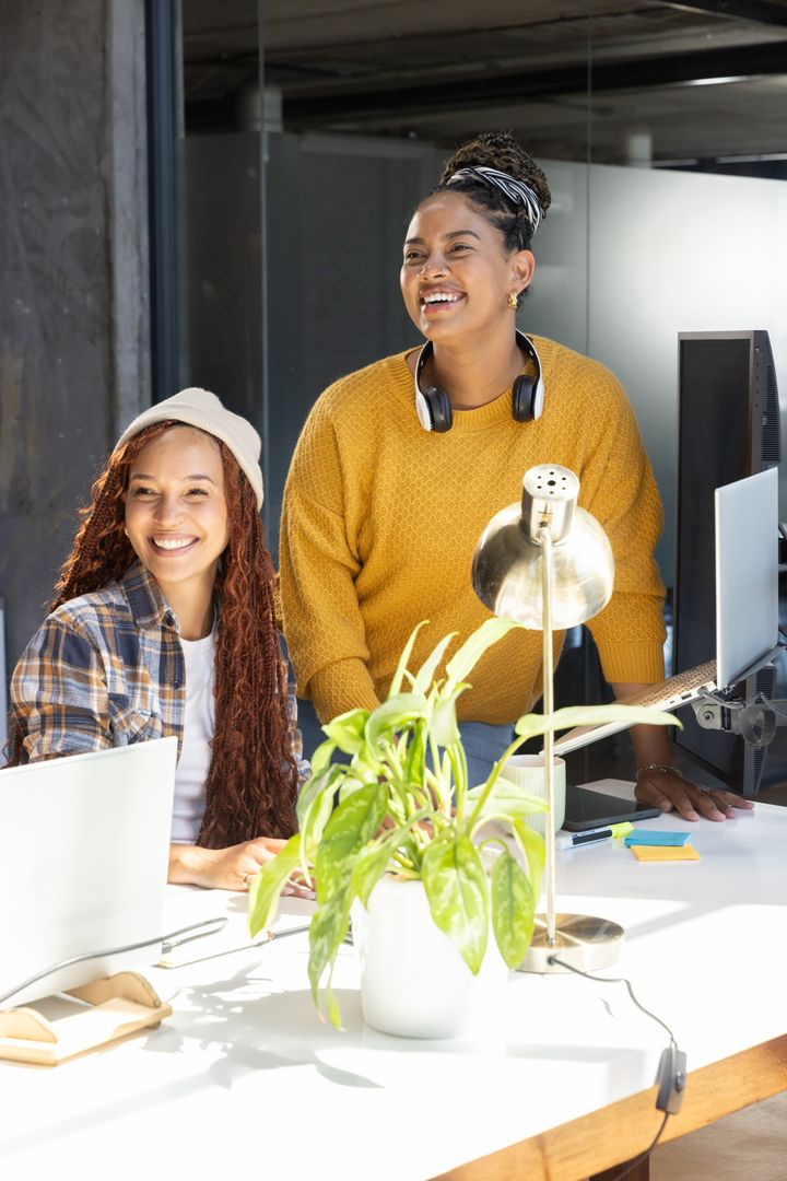Two Female Professionals Collaborating in Modern Office