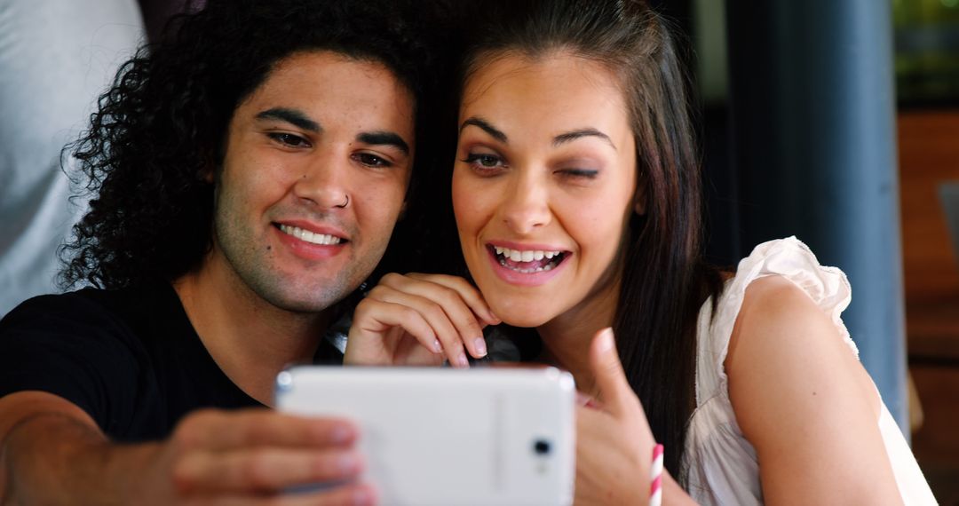 Excited Couple Enjoying Content on Smartphone Together