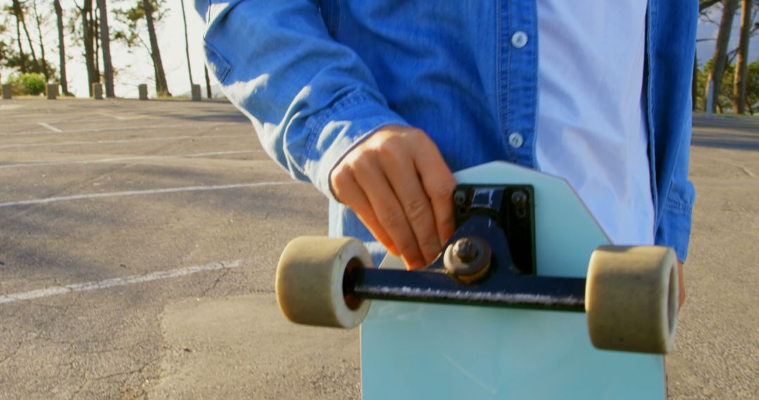 Closeup of Skateboarder Holding Longboard on Empty Street - Free Images, Stock Photos and Pictures on Pikwizard.com