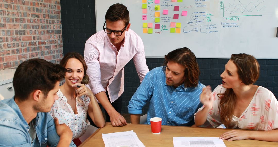 Team Engaging in Creative Problem Solving Around Conference Table