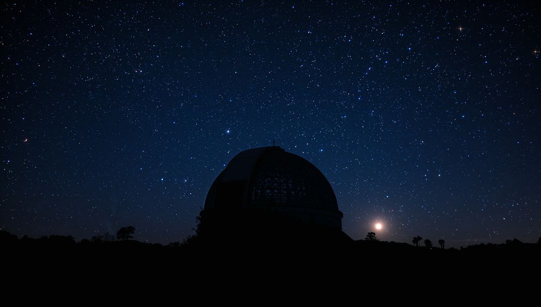 Observatory dome silhouetting against vast starfield with rising moon and distant trees