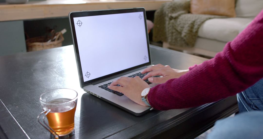 Person Typing on Laptop at Home with Tea on Coffee Table - Free Images, Stock Photos and Pictures on Pikwizard.com