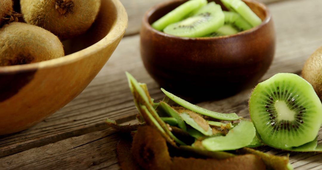 Fresh Kiwis Peeled and Sliced in Wooden Bowls - Free Images, Stock Photos and Pictures on Pikwizard.com