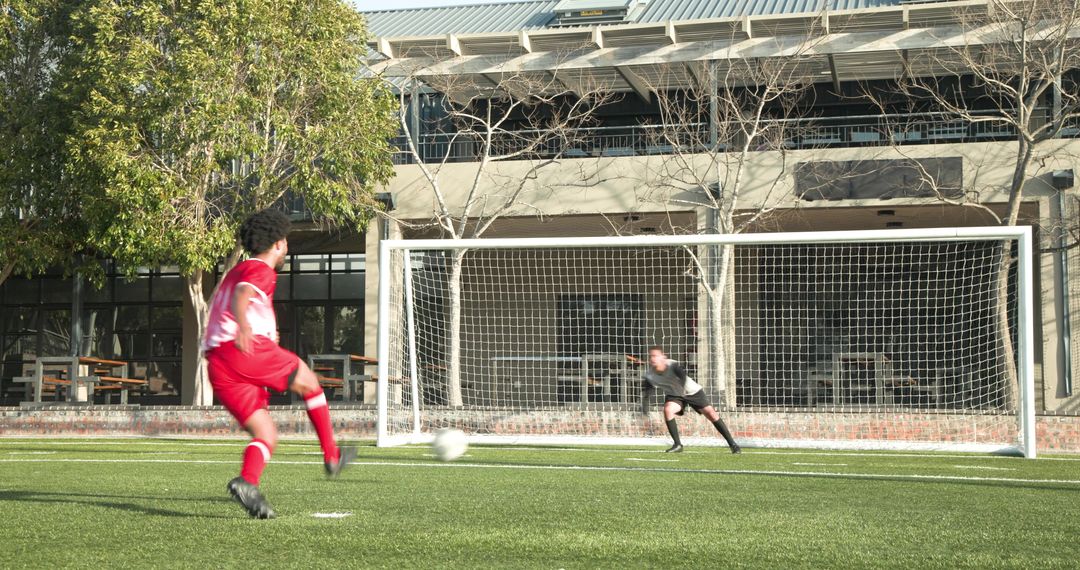Soccer Player Taking Penalty Shot on Sunny Afternoon