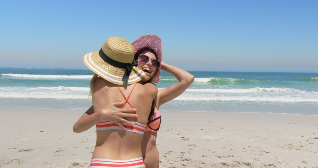 Two Women Enjoying Summer Vacation on Sunny Beach - Free Images, Stock Photos and Pictures on Pikwizard.com