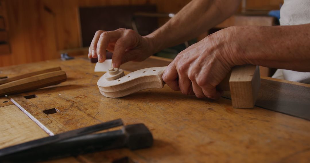 Craftsman Carving Wooden Guitar Neck in Workshop - Free Images, Stock Photos and Pictures on Pikwizard.com