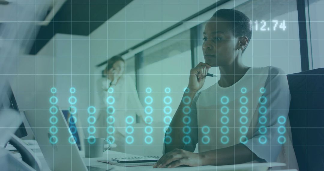 Focused African American Woman Analyzing Data on Laptop in Office