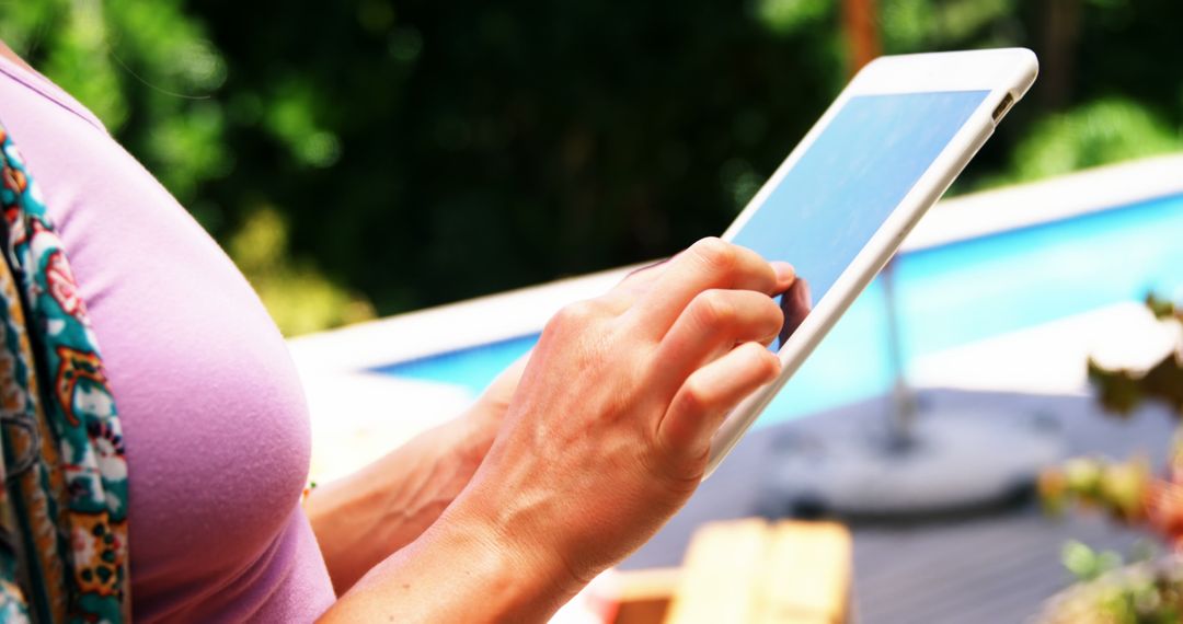 Person Using a Tablet by the Poolside - Free Images, Stock Photos and Pictures on Pikwizard.com