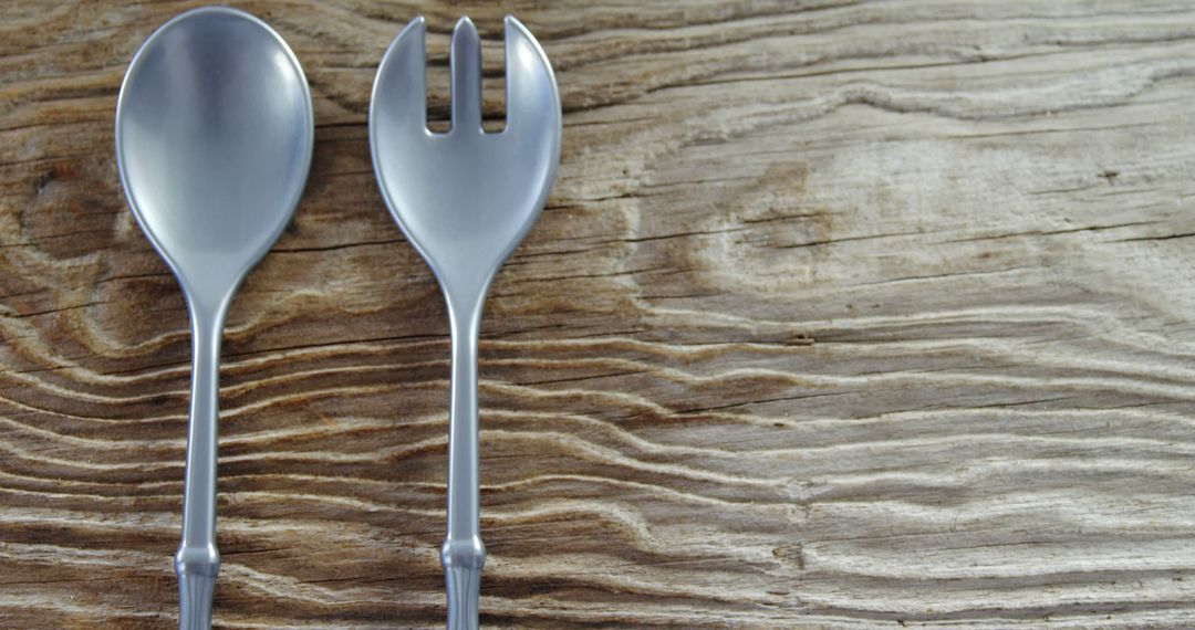 Spoon and Spork on Rustic Wooden Surface with Copy Space - Free Images, Stock Photos and Pictures on Pikwizard.com