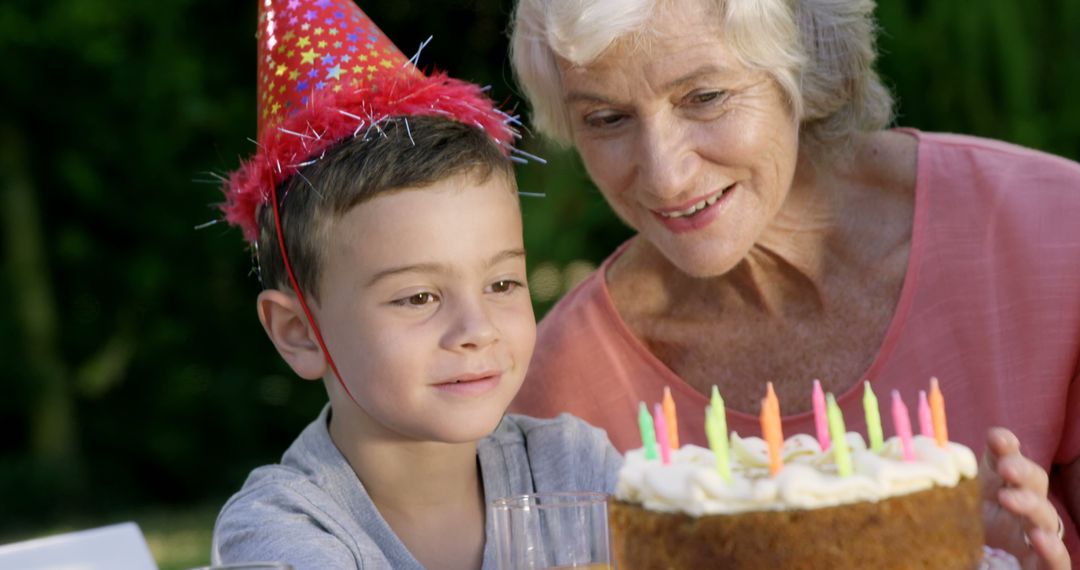 Grandmother and Grandson Celebrating Birthday Outdoors - Free Images, Stock Photos and Pictures on Pikwizard.com