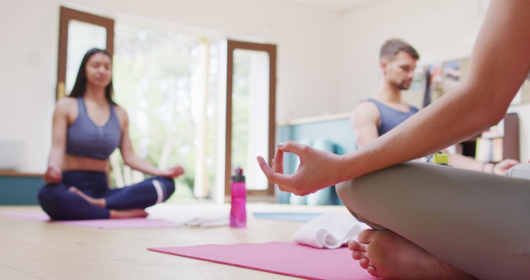 Multi-Ethnic Group Practicing Yoga in Modern Studio