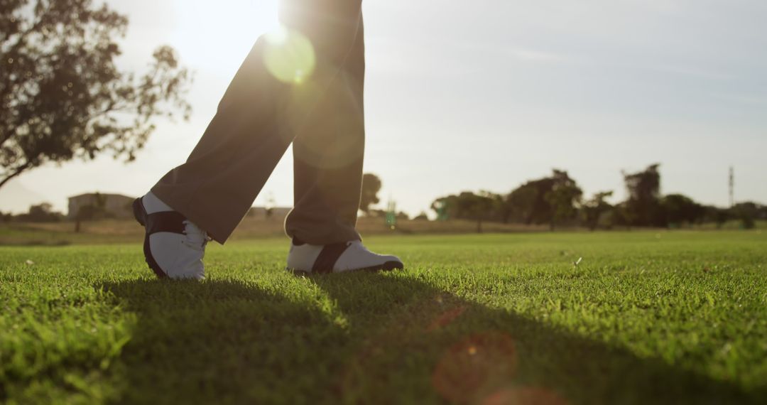 Golfer's Footsteps on Green Course with Sunlight - Free Images, Stock Photos and Pictures on Pikwizard.com