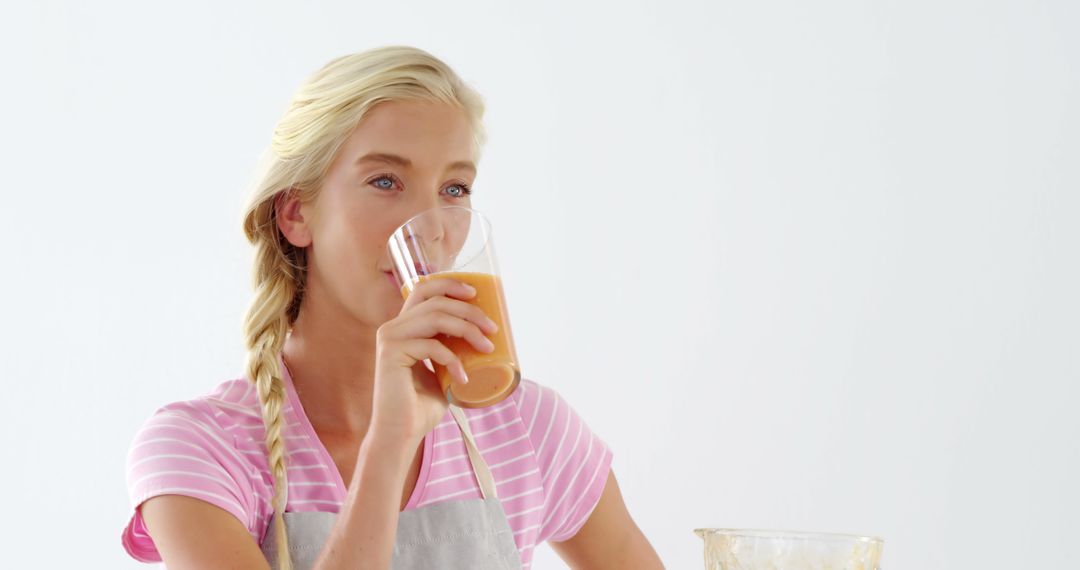 Young Woman Drinking Homemade Smoothie in Bright Kitchen - Free Images, Stock Photos and Pictures on Pikwizard.com