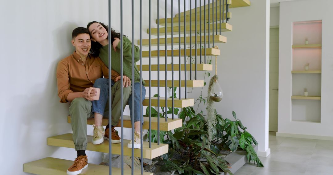 Couple Relaxing on Stylish Modern Floating Staircase with Greenery and Minimalist Design