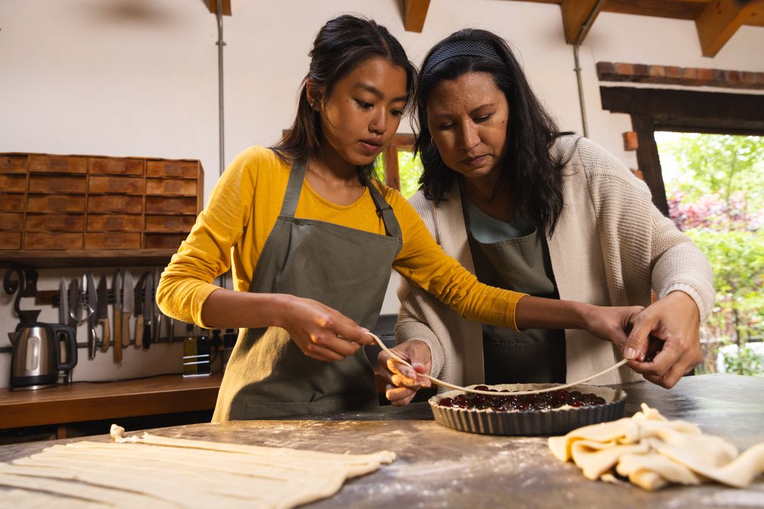 Mother and Daughter Baking Cherry Pie Together in Rustic Kitchen
