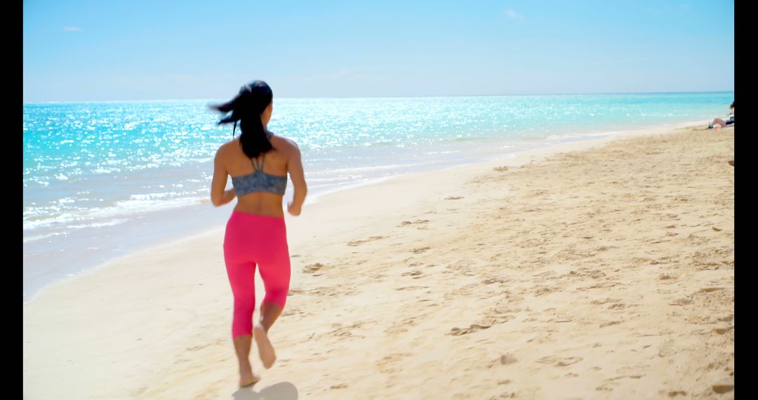 Fit woman running on beach in bright sunlight - Free Images, Stock Photos and Pictures on Pikwizard.com