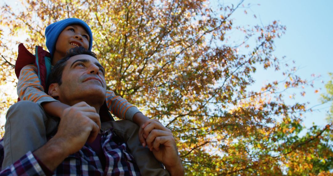 Father Carrying Son on Shoulders During Autumn Walk - Free Images, Stock Photos and Pictures on Pikwizard.com