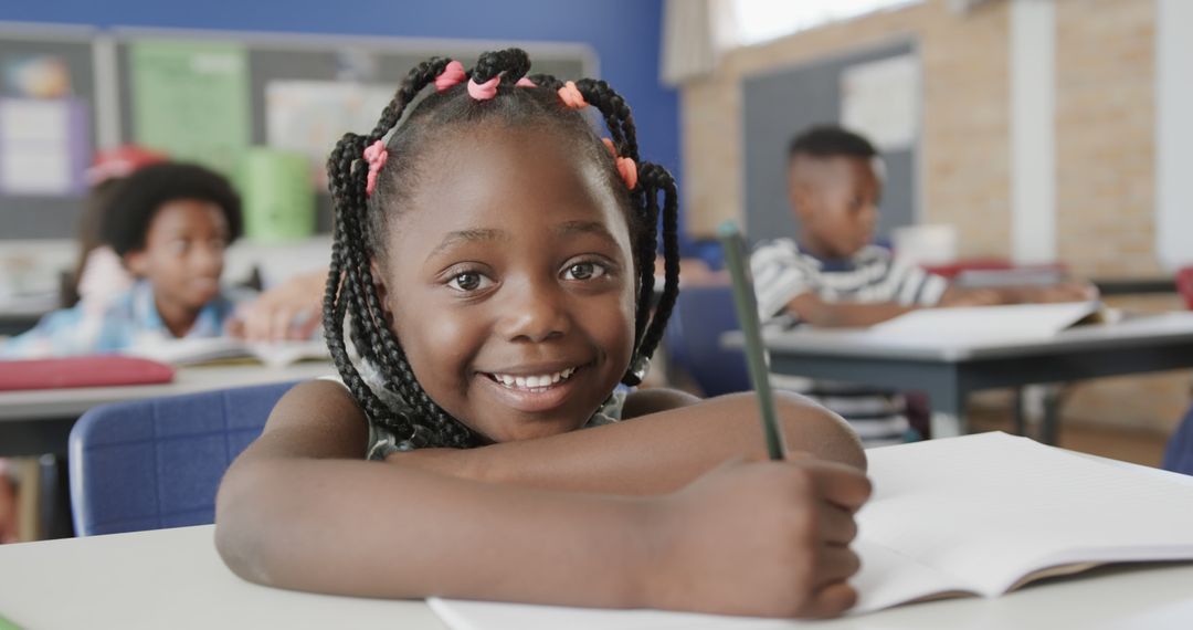 Smiling Student Writing in Notebook in Classroom - Free Images, Stock Photos and Pictures on Pikwizard.com