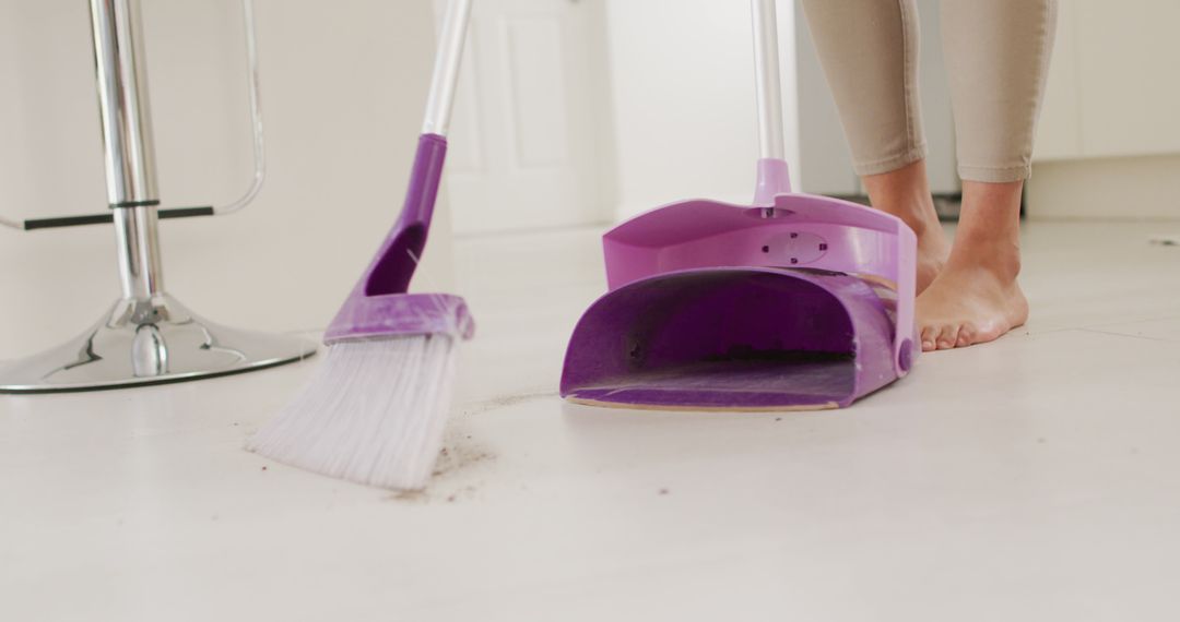 Person Sweeping Floor with Purple Dustpan and Broom in Home Interior - Free Images, Stock Photos and Pictures on Pikwizard.com