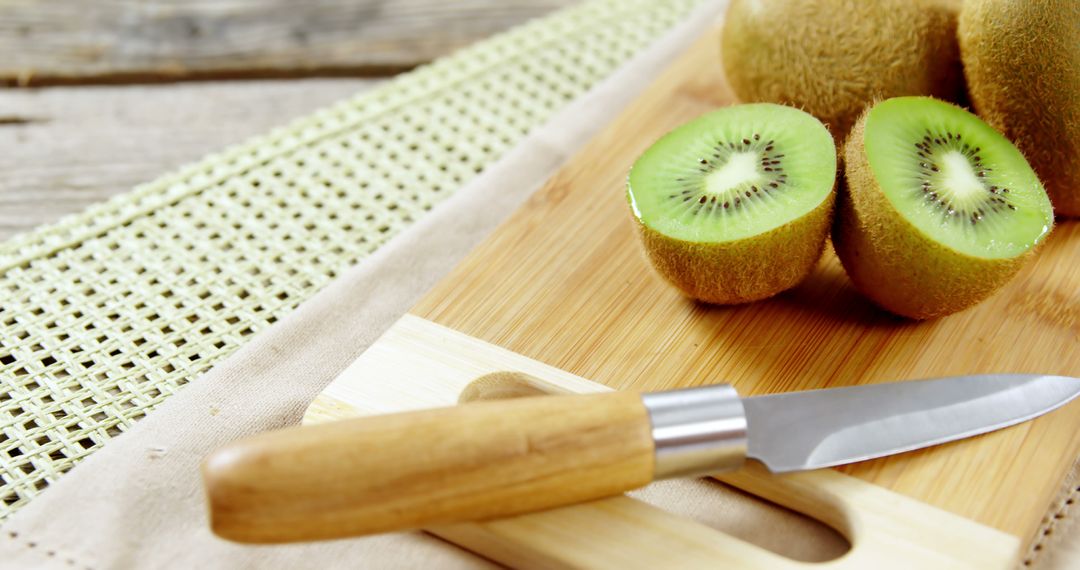 Sliced Kiwi with Knife on Wooden Cutting Board - Free Images, Stock Photos and Pictures on Pikwizard.com