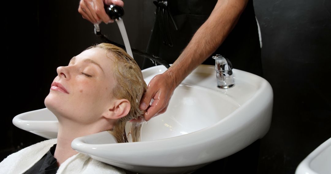 Woman Relaxing While Washing Hair at Salon - Free Images, Stock Photos and Pictures on Pikwizard.com