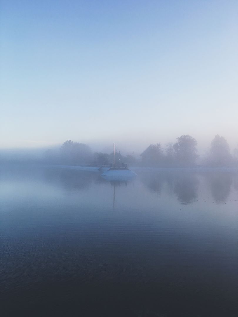 Tranquil Boat on Misty Lake at Sunrise - Free Images, Stock Photos and Pictures on Pikwizard.com