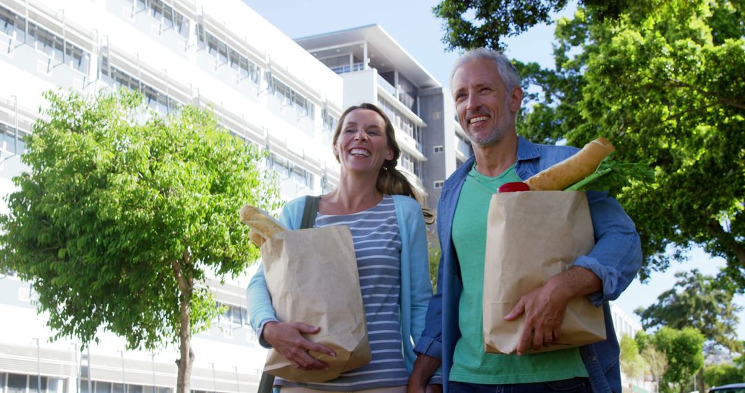 Mature Couple Enjoying a Sunny Day with Groceries