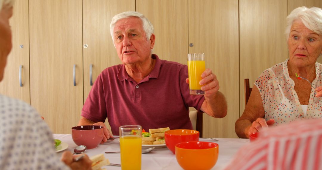 Family Breakfast Gathering with Seniors Sharing Orange Juice - Free Images, Stock Photos and Pictures on Pikwizard.com