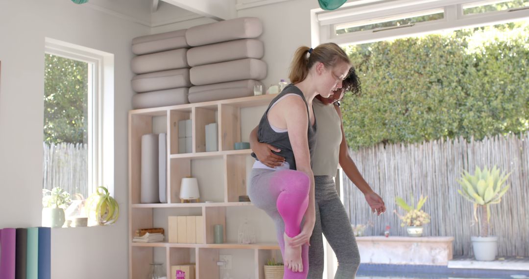 Fitness Instructor Helping Woman with Yoga Pose in Bright Studio - Free Images, Stock Photos and Pictures on Pikwizard.com