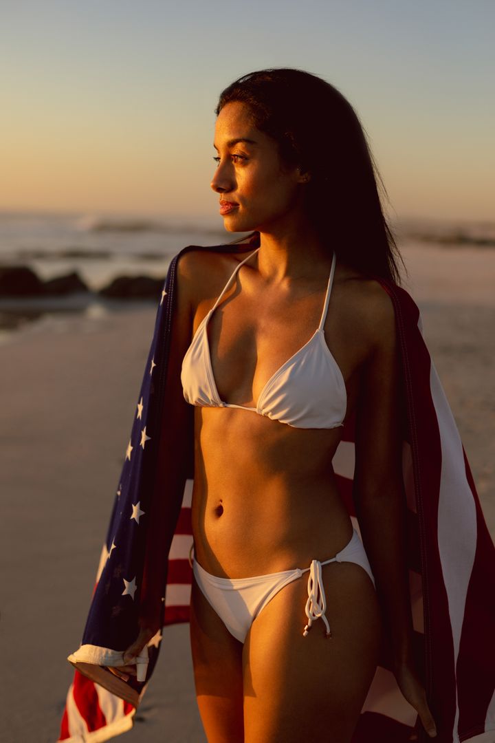 Beautiful Woman with American Flag on Beach at Sunset - Free Images, Stock Photos and Pictures on Pikwizard.com