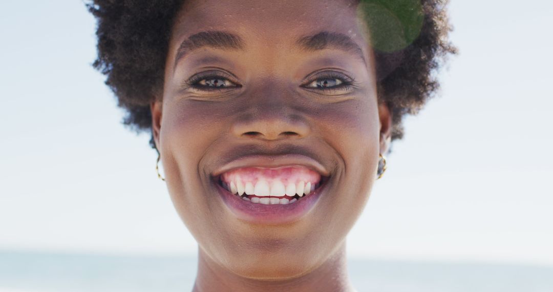 Close-Up of Smiling Woman with Natural Hair Outdoors - Free Images, Stock Photos and Pictures on Pikwizard.com