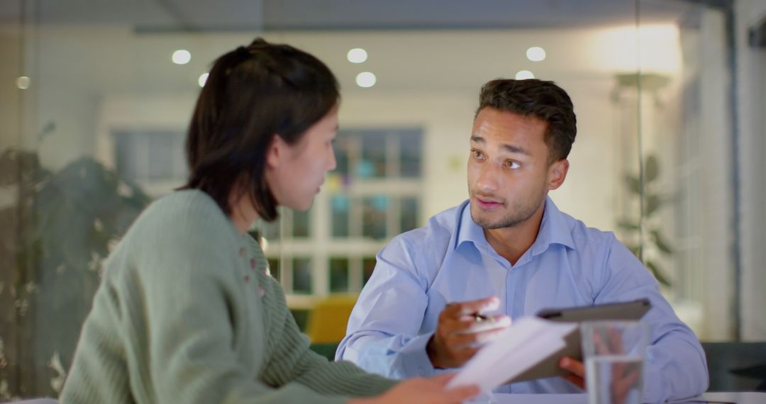 Diverse Colleagues Discussing Work on Tablet in Casual Office