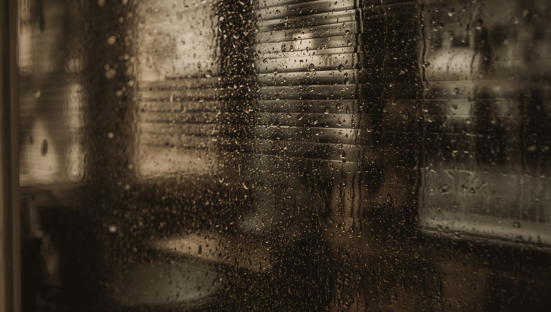 Rain-Splattered Window Framing Blurred Living Room with Blinds and Moody Sepia Light