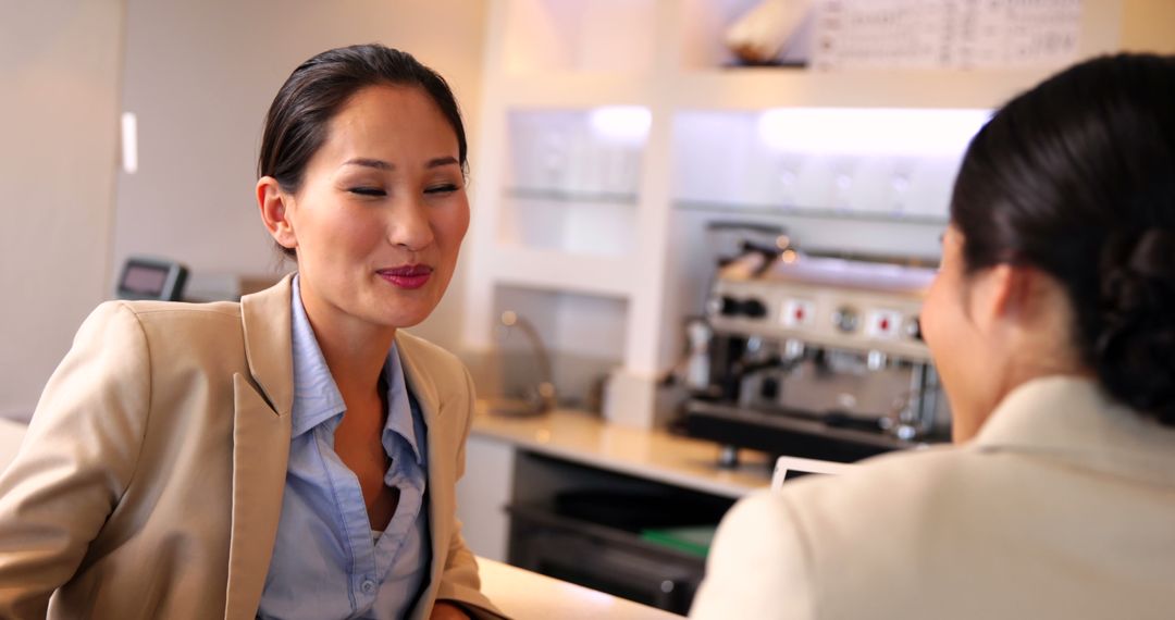 Two Businesswomen Enjoying Relaxing Time at Café Bar