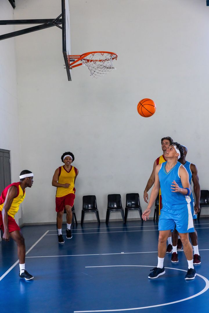 Intense Basketball Game with Players Competing Near Hoop