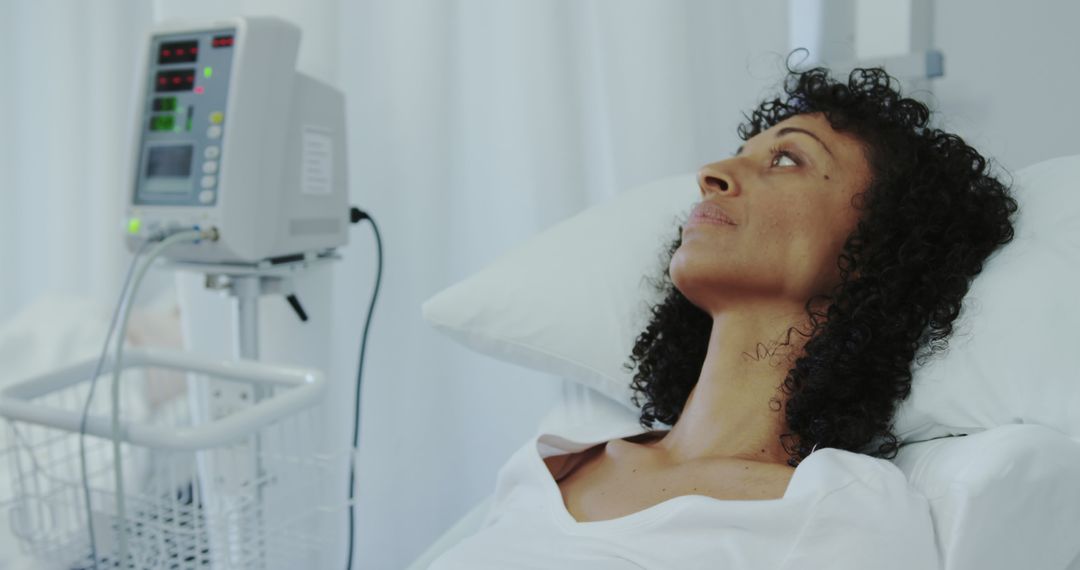 Woman Resting in Hospital Bed Connected to Medical Equipment - Free Images, Stock Photos and Pictures on Pikwizard.com