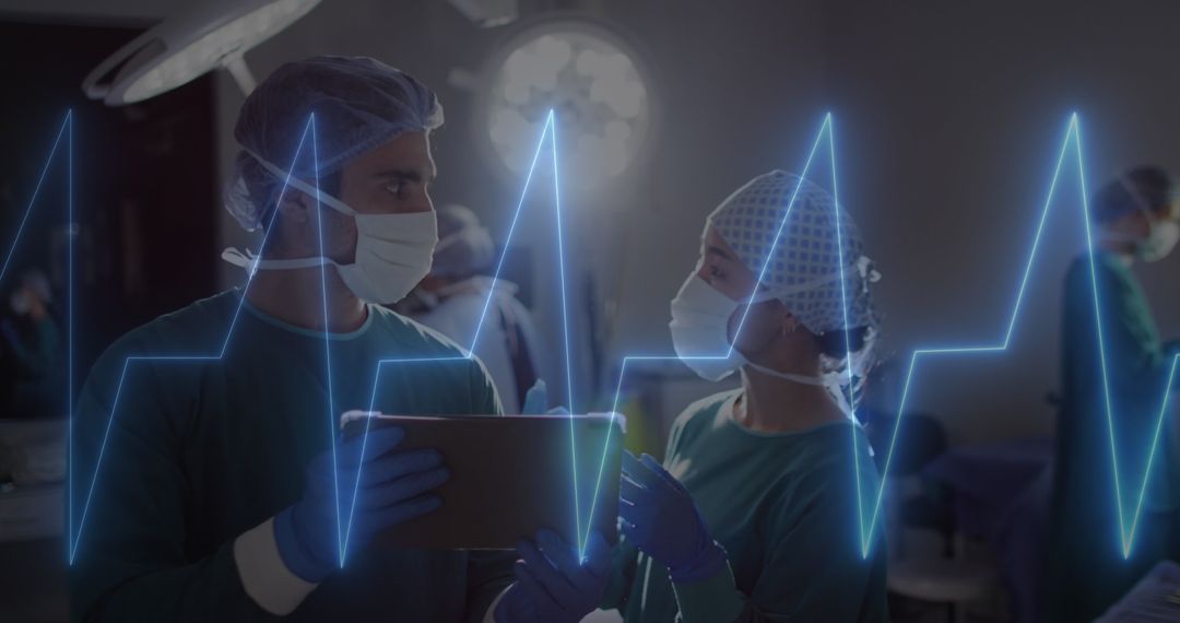 Surgeons Analyzing Data with Cardiograph Interface at Hospital