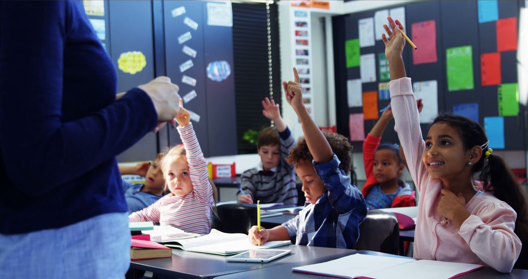 Enthusiastic Elementary Students Raising Hands in Class - Free Images, Stock Photos and Pictures on Pikwizard.com