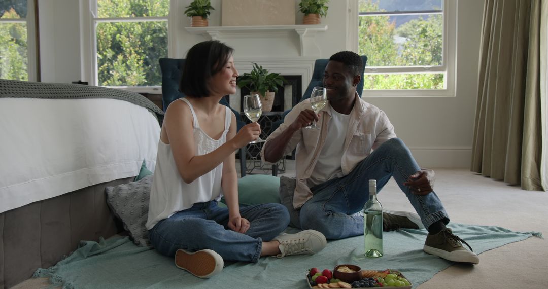 Couple Enjoying Wine and Relaxing Indoor Picnic