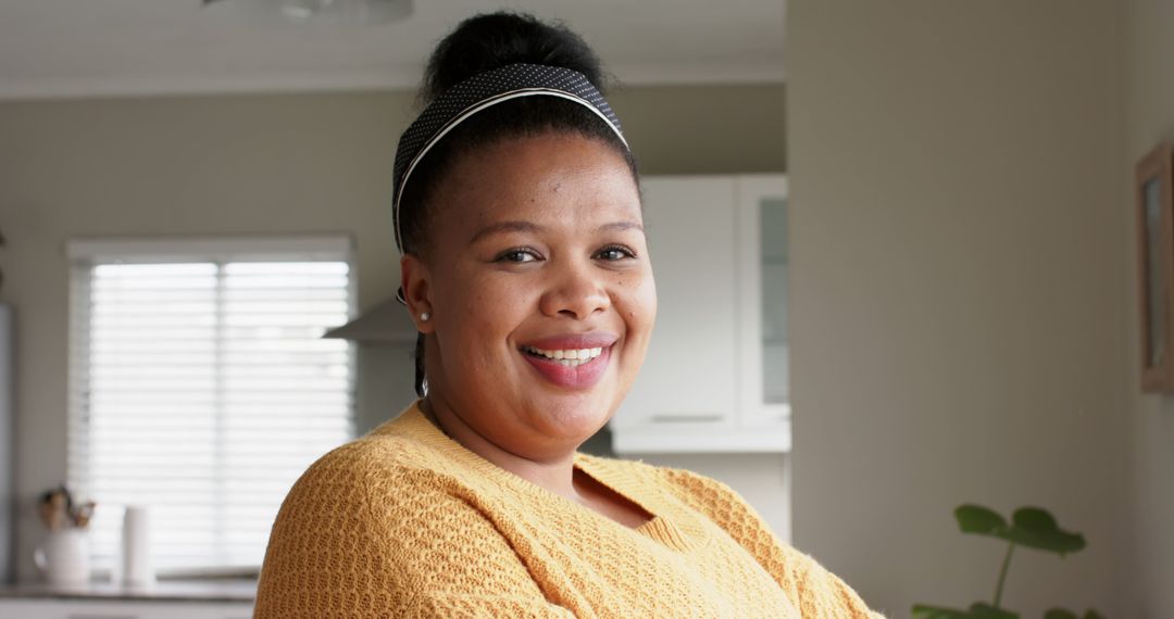 Smiling African American Woman in Yellow Sweater at Home - Free Images, Stock Photos and Pictures on Pikwizard.com