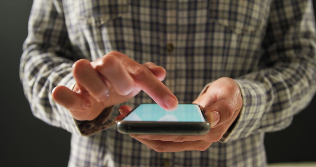 Person Using Smartphone Wearing Checkered Shirt - Free Images, Stock Photos and Pictures on Pikwizard.com