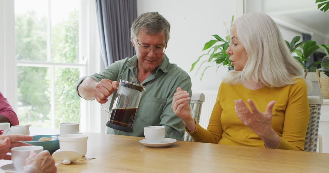Image of happy caucasian female and male senior friends drinking coffee at home - Free Images, Stock Photos and Pictures on Pikwizard.com