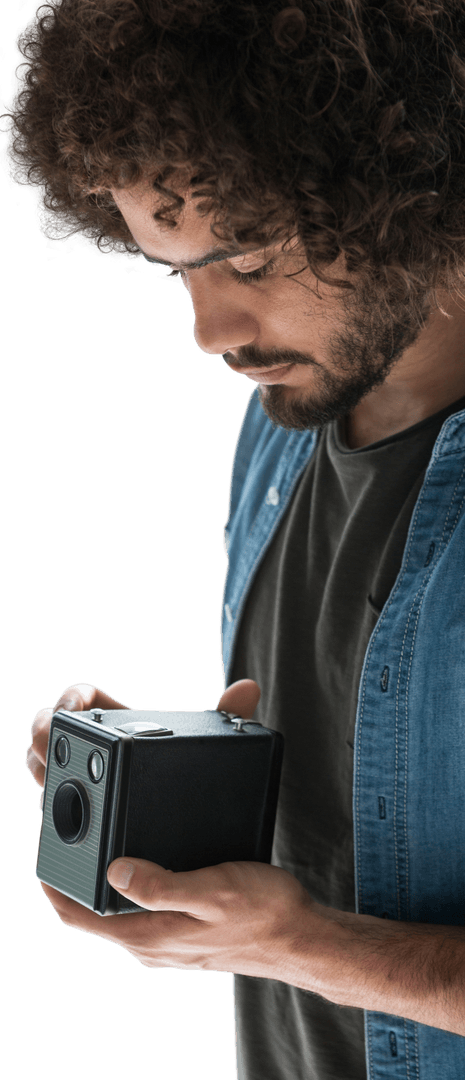 Curly-Haired Artist Focusing Dramatically on Vintage Camera